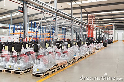 Large hangar warehouse of industrial and logistics companies. New pallet trucks in stock. industry space and hardware box for Editorial Stock Photo
