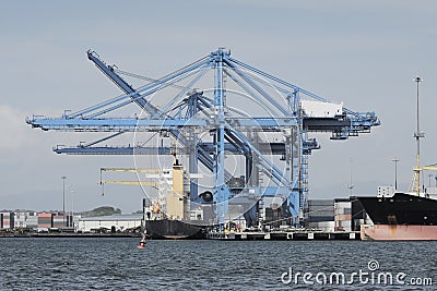 Large harbor cranes at a commercial dock Stock Photo