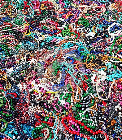 Large heap of women`s multicolored cheap necklaces. Fashion, background and texture Stock Photo