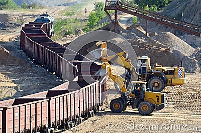 Large heavy front-end loader or all-wheel bulldozer for mechanization of loading, digging and excavation operations in open quarry Stock Photo