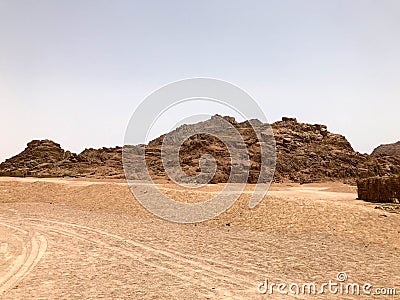 A large high stone sandy mountain in the desert with sand background Stock Photo