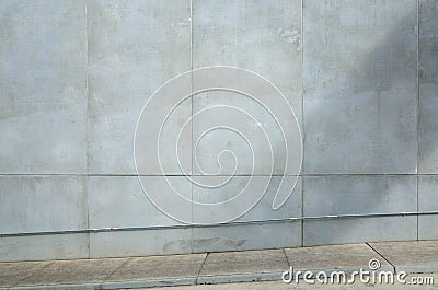 A large high urban blank wall in natural sunlight with copy space room to add your own text or banner. Industrial background Stock Photo