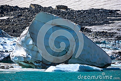 Large Iceberg At The Edge of Grinnell Glacier Lake Stock Photo