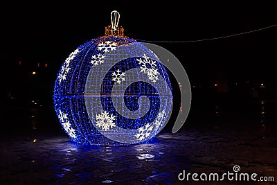 Large illuminated Christmas bauble on city square Stock Photo