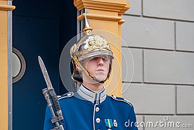 A large image of a security guard outside a guard box on the grounds of the royal palace in Stockholm Editorial Stock Photo
