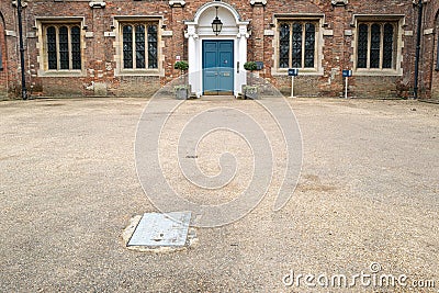 Large and impressive entrance to a private school showing the large parking area. Stock Photo