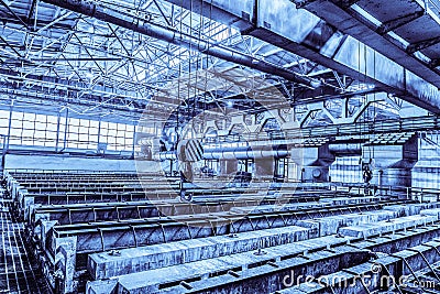 Large industrial bath for galvanizing steel metal products. Background in blue tone. Stock Photo