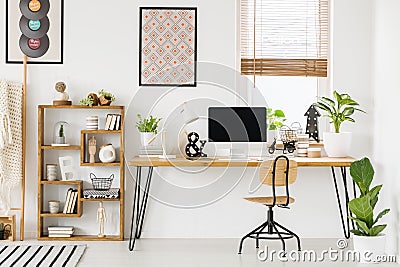 Large industrial desk with a computer by a window, a wooden book Stock Photo