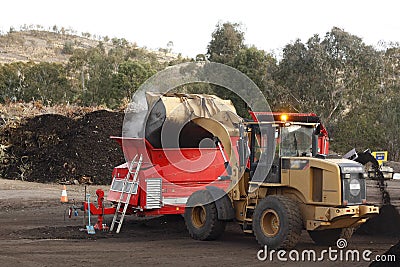 Large industrial machinery being used at a garbage dump Stock Photo