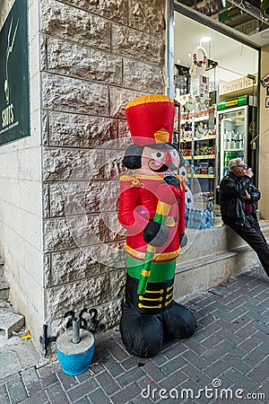 A large inflatable figure of the Nutcracker is standing on the street in Bethlehem in Palestine Editorial Stock Photo