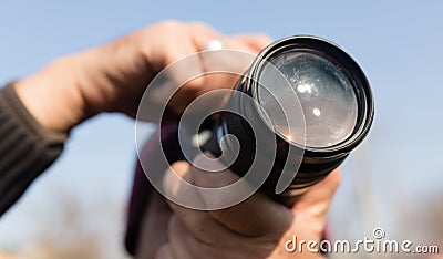 A large lens in the camera of a man Stock Photo