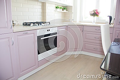 Large light pink kitchen. Interior of a pink kitchen. Wooden Kitchen Editorial Stock Photo