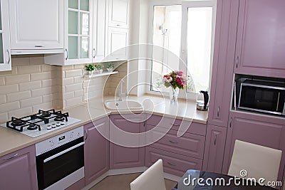 Large light pink kitchen. Interior of a pink kitchen. Wooden Kitchen Editorial Stock Photo