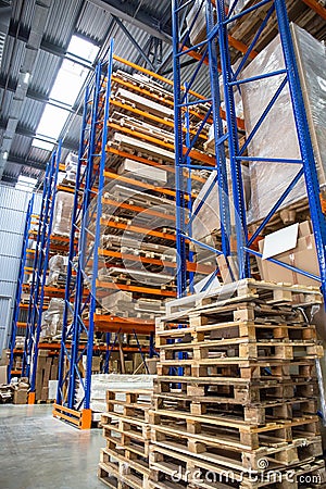 Large Logistics hangar warehouse with lots shelves or racks with pallets of goods. Industrial shipping and cargo delivery Stock Photo