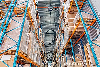 Large Logistics hangar warehouse with lots shelves or racks with pallets of goods. Industrial shipping Stock Photo