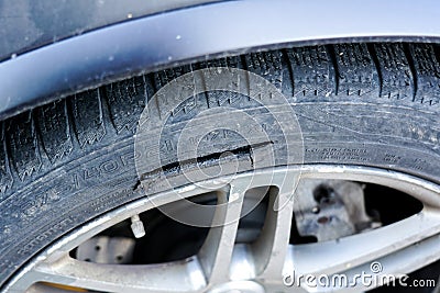 Large long mechanical cut damage on tire sidewall Stock Photo