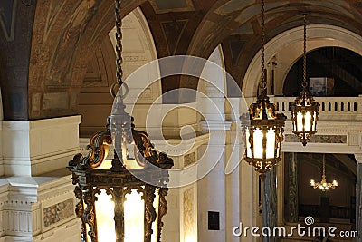 Large luxurious lanterns hanging from the ceiling of cathedral Stock Photo