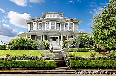 Large luxury green craftsman classic American house exterior. Stock Photo