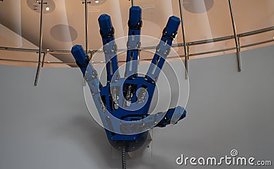 A large mechanical hand opened in a welcoming gesture. Robot exhibition with a demonstration of a large mechanical Stock Photo