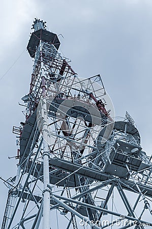 Large metal tower with various radio equipment, metal structure close-up, bottom up view. Editorial Stock Photo