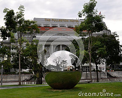 Large metallic sphere in front of The Fullerton Hotel in Singapore Editorial Stock Photo