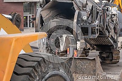 Large milling machine removing an old pavement layers at full depth Stock Photo