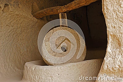 Large millstone in cave, Zelve Valley, Cappadocia, Turkey Stock Photo