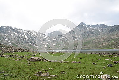 Large mountains covered with snow and dramtic clouds. Photo about mountains and lakes . Stock Photo