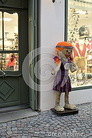 Riga, Latvia, November 2019. Traditional Latvian straw doll at the entrance to the store. Editorial Stock Photo