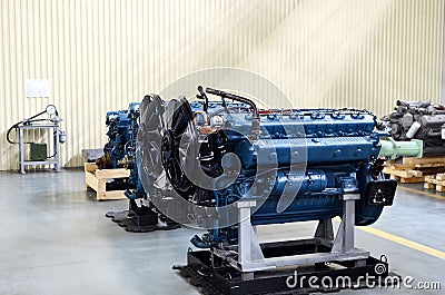 Large new diesel engines in the workshop of the factory for the production of trucks. Car`s motor. Stock Photo