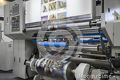 Large offset printing press or magazine running a long roll off paper in production line of industrial printer machine Stock Photo