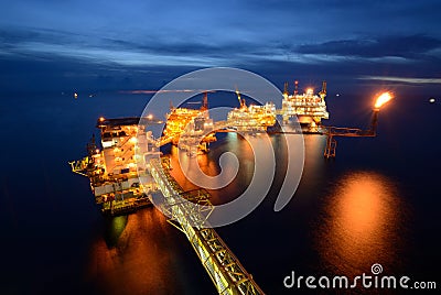 The large offshore oil rig drilling platform at night Stock Photo