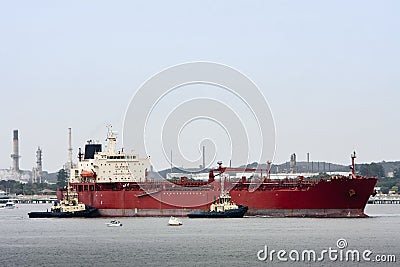 Large oil tanker with two tugs Stock Photo