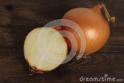 Large onion whole and cut on a wooden table, concept of vegetables for health against colds, horizontal, closeup, copy space Stock Photo