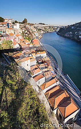 Large panoramic view on Porto sity and Ribeira district roofs from Dom Luis I Bridge at sunset time Stock Photo