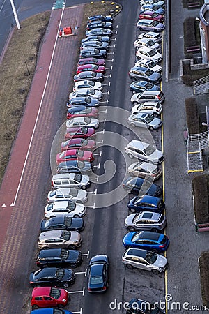 large parking lot for cars in front of a multi-storey residential building view from above Stock Photo