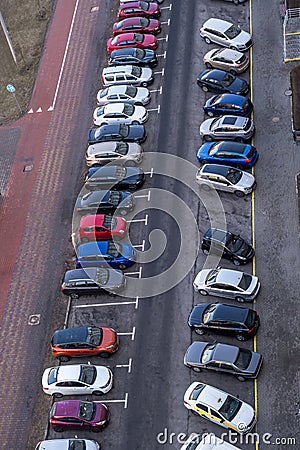 large parking lot for cars in front of a multi-storey residential building view from above Stock Photo