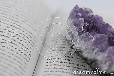 A large piece of Amethyst on an open book Stock Photo