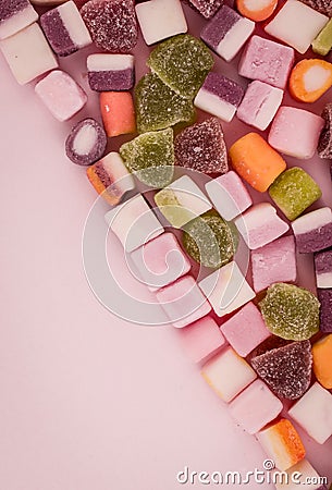 A large pile of mixed sweets on wooden background Stock Photo