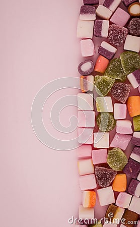 A large pile of mixed sweets on wooden background Stock Photo