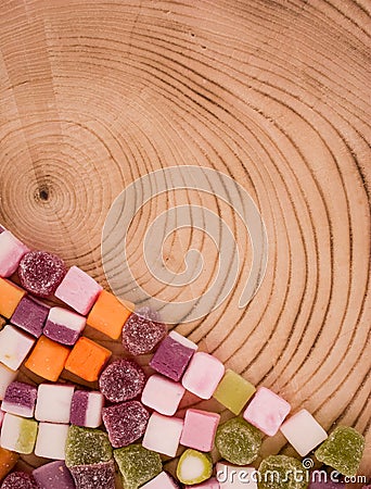 A large pile of mixed sweets on wooden background Stock Photo