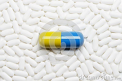 Large pill with small pills Stock Photo