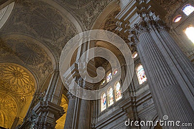 Large pillars, vaults and stained glass windows in Malaga Cathedral, Spain Editorial Stock Photo