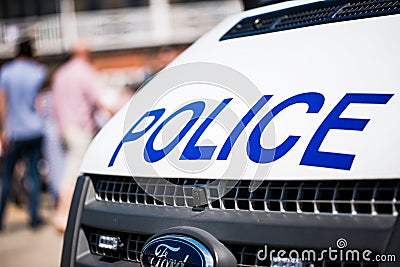 Large police sign on the front of a white patrol vehicle. Editorial Stock Photo