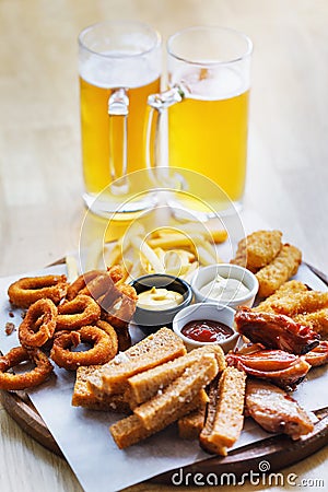 Large portion of snacks and 2 glasses of light beer Stock Photo