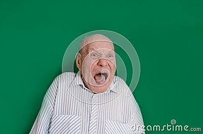 a large portrait of a crazy old man on an isolated green background. chromakey Stock Photo