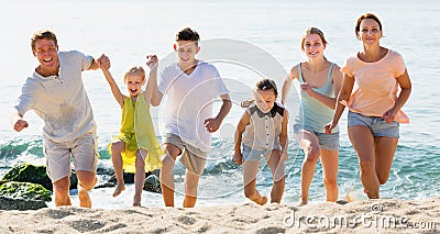 Large positive family of six people running together Stock Photo