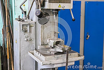 A large powerful iron metal bench-type screw-cutting lathe for the manufacture of parts and spare parts with handles and buttons, Stock Photo