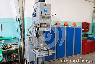 A large powerful iron metal bench-type screw-cutting lathe for the manufacture of parts and spare parts with handles and buttons, Stock Photo