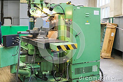 A large powerful iron metal bench-type screw-cutting lathe for the manufacture of parts and spare parts with handles and buttons, Stock Photo